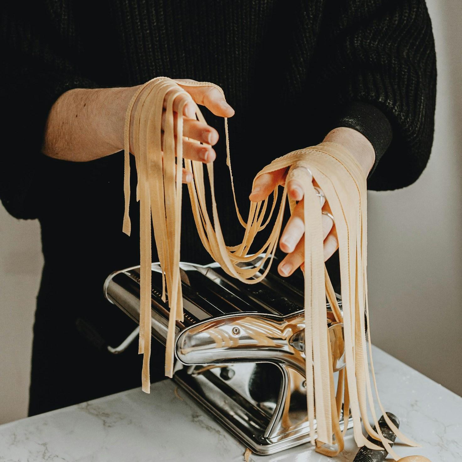 Diverse group of community members sharing a meal together, showcasing the social bonds formed through collaborative cooking